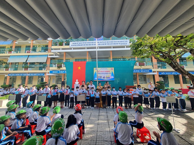 Cán bộ Phòng CSGT Công an tỉnh và Đại diện lãnh đạo Công ty Xổ số kiến thiết tỉnh BR-VT trao nón bảo hiểm và tập vở cho các em học sinh Trường TH Lê Thành Duy