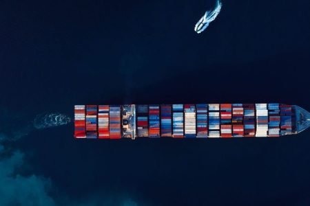 A container ship at deep blue sea from above