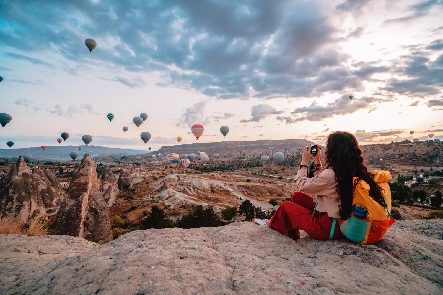 Cô gái nhiếp ảnh gia du lịch chụp ảnh khinh khí cầu khi mặt trời mọc ở Cappadocia